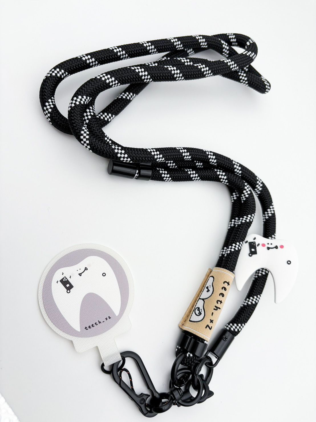 兩顆牙齒的手機掛繩