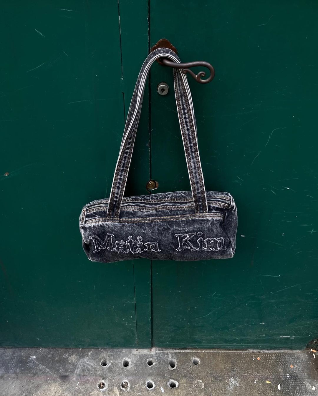 MATIN KIM LOGO WASHED DENIM DUFFEL BAG IN